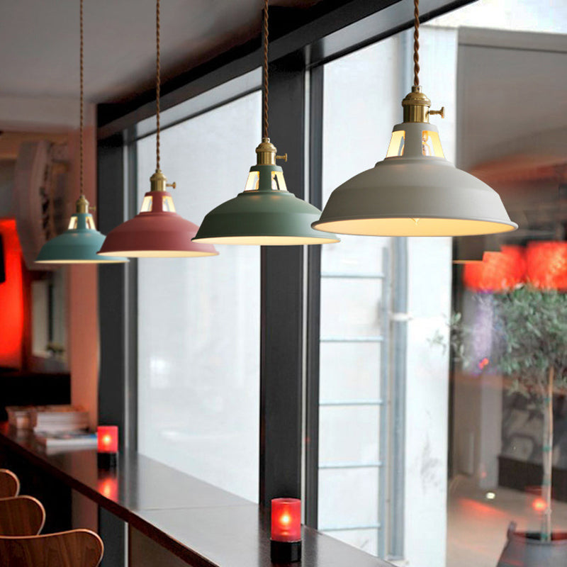 Three barn pendants above a cafe counter beside a bright window