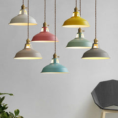 Six colored barn pendants hanging at mixed heights in a living room