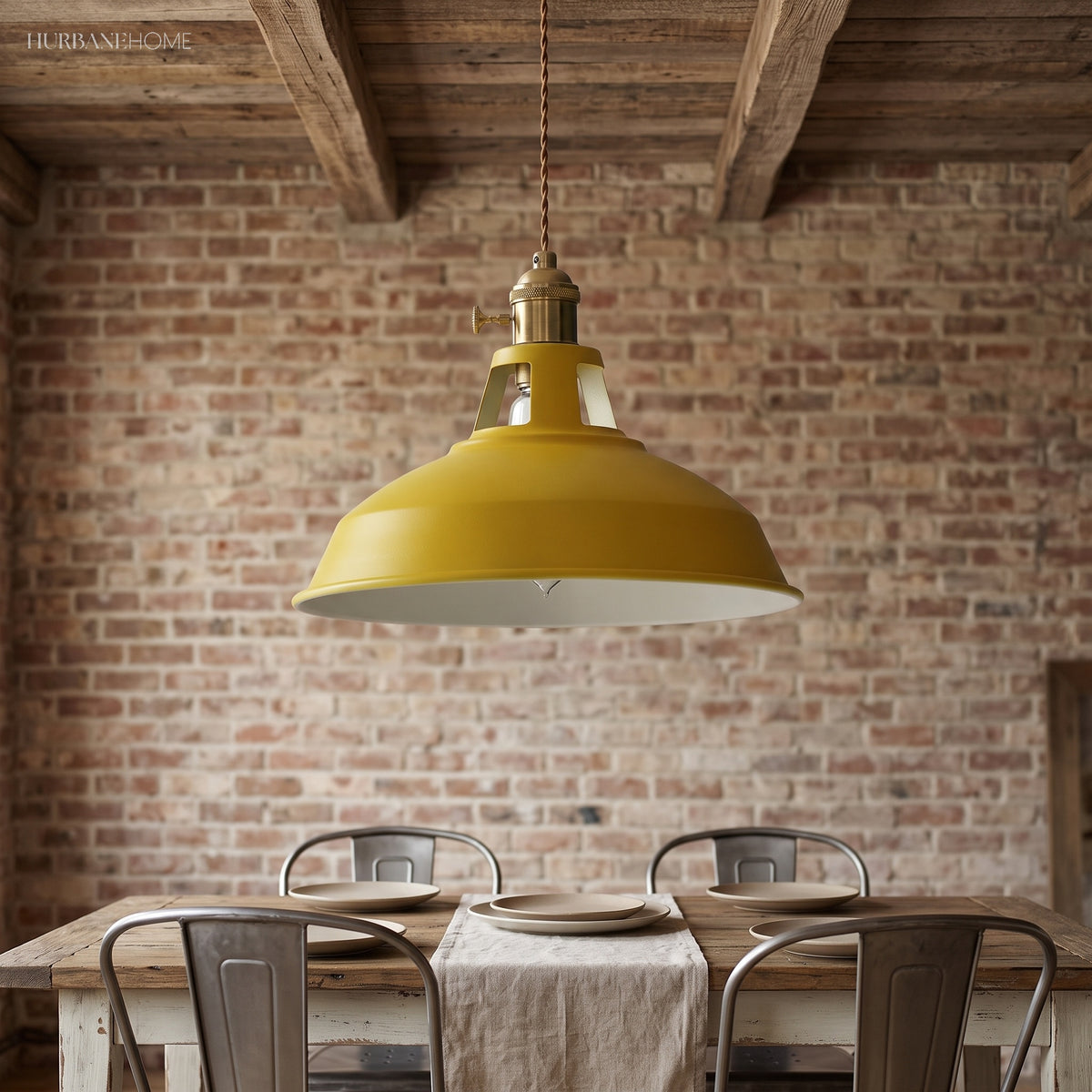 Yellow barn shade pendant over a dining table against exposed brick