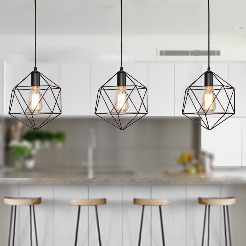 Three black cage pendants in a row above a white kitchen island