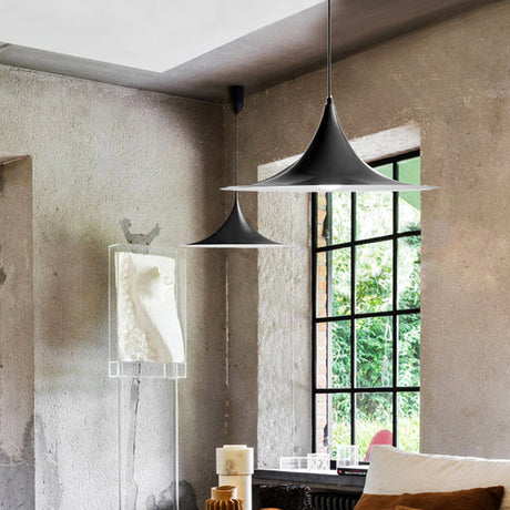 Black and white flared pendants in a concrete room with windows