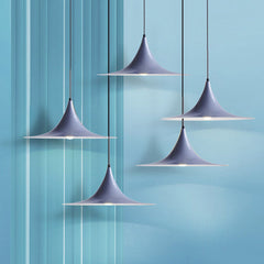 Grey flared pendants hung at staggered heights on a blue backdrop