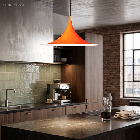 Orange flared pendant lit over a dark kitchen bench and sink