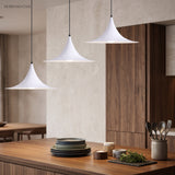 Two white flared pendants above a timber kitchen bench and plates