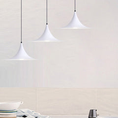 Three white flared pendants stepped down a pale tiled wall
