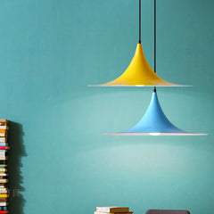 Yellow and blue flared pendants against a bright teal painted wall