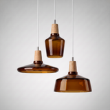Three amber glass shades hung together at staggered heights