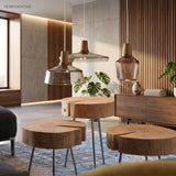 Cluster of glass and wood pendants above round timber tables
