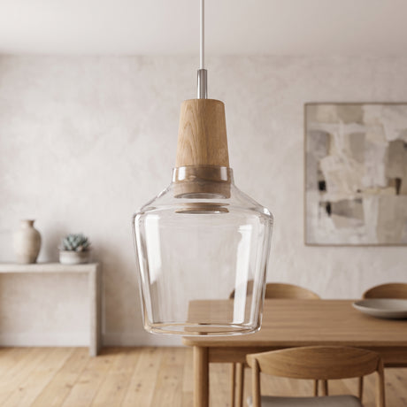 Clear glass pendant with a wood top hanging above a pale dining table