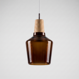 Tall amber glass bell shade with a wood top on a grey background