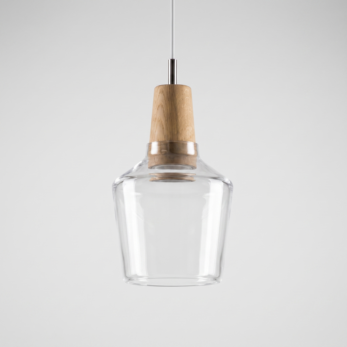 Tall clear glass bell shade with a natural wood top on a cable