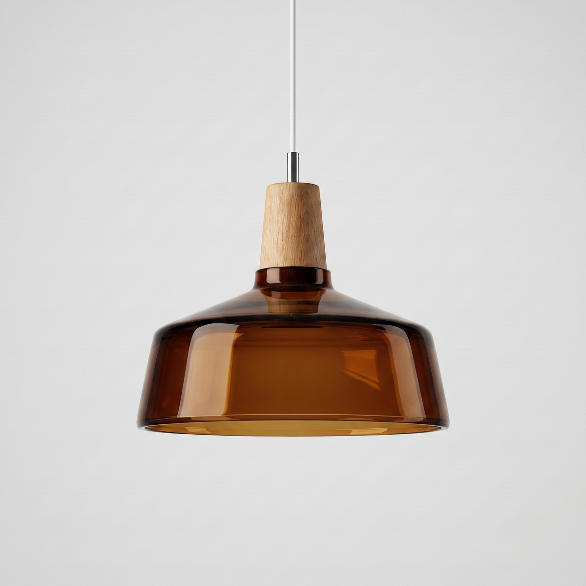 Amber glass bowl shade with a wood top seen against grey