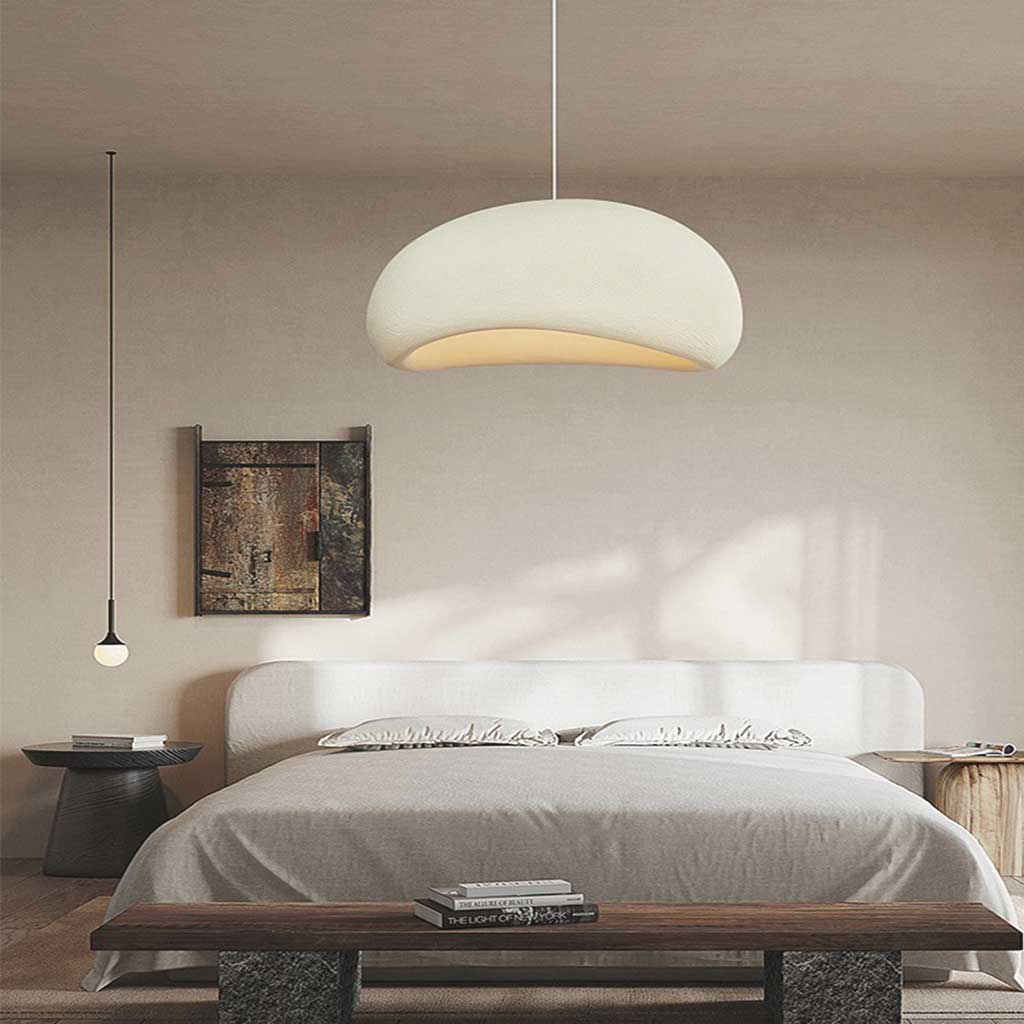 White dome pendant lit above a bed with a timber bench