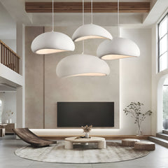 Cluster of white dome pendants lit above a round rug and sofa
