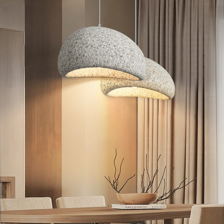 Grey dome pendant lit warm above a small round table