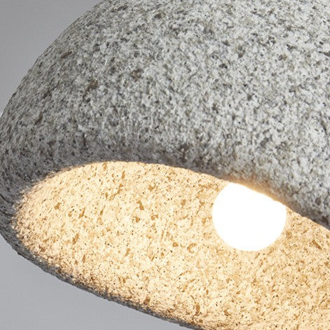 Close view of the shade rim with the bulb glowing behind it