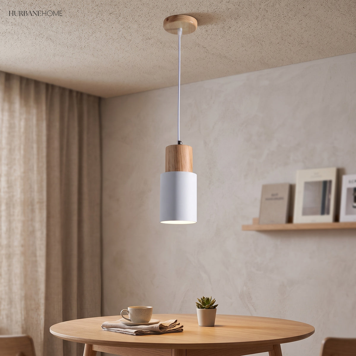 Pale gray cylinder pendant above a small round dining table