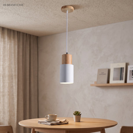 Pale gray cylinder pendant above a small round dining table