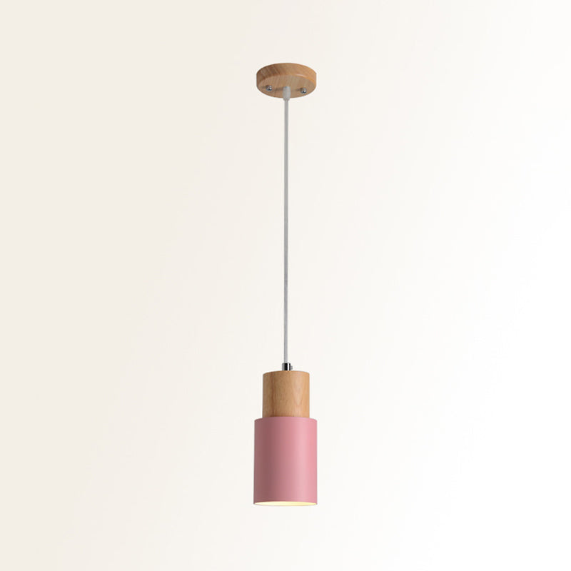 Studio shot of the pink cylinder pendant and natural wood top