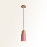 Studio shot of the pink cylinder pendant and natural wood top