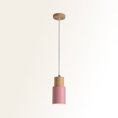 Studio shot of the pink cylinder pendant and natural wood top