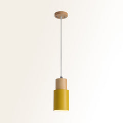 Studio shot of the yellow metal cylinder pendant on cream
