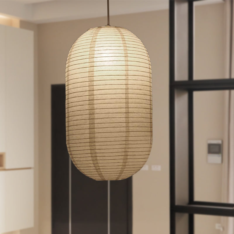 Oval capsule paper lantern hanging beside a black framed doorway