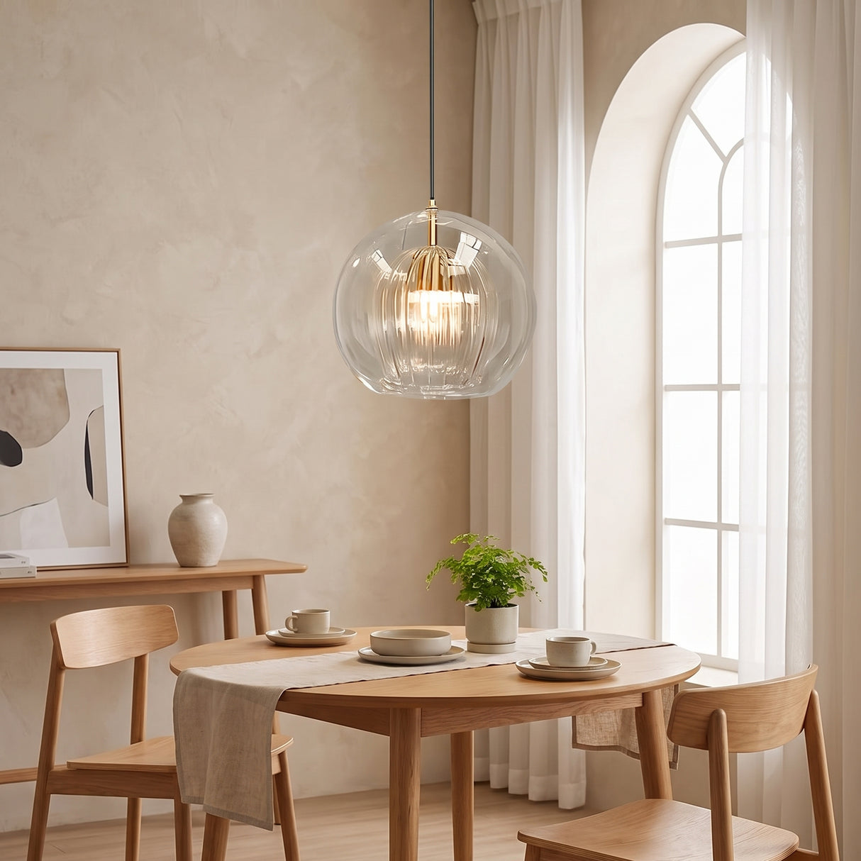 Single large ribbed glass globe pendant above a round table by an arched window