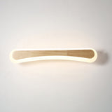 Curved wood and acrylic bar lit warm on a plain background