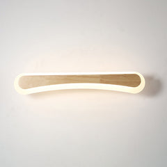 Curved wood and acrylic bar lit warm on a plain background