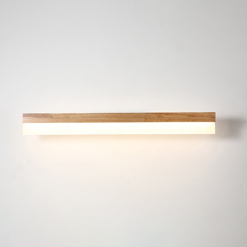Straight wood and acrylic bar lit warm on a plain background