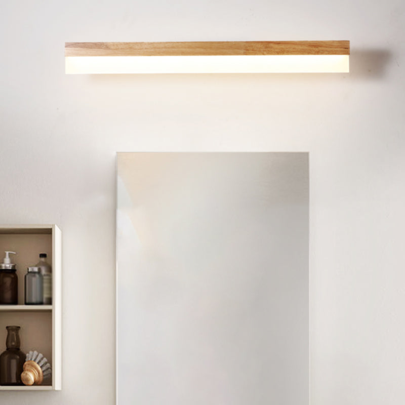 Straight wood vanity light above a tall mirror and open shelving