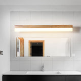 Straight wood vanity light above a wide mirror in a tiled bathroom