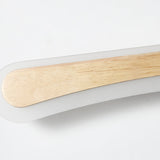 Close view of the wood inlay set into the white acrylic body