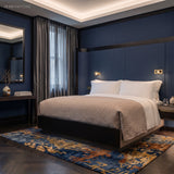 Bedside reading sconces in a navy panelled hotel style bedroom