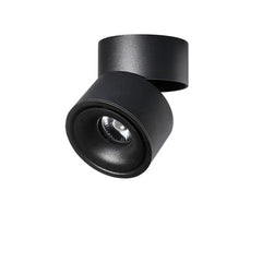 Black rotating ceiling spotlight angled forward on its folding arm