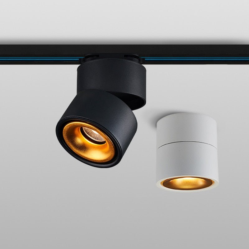 Black and white rotating ceiling spotlights with gold inner reflectors