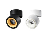 Black and white rotating spotlights side by side with gold reflectors