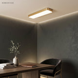 Gold LED ceiling panel lit above a desk and a black chair
