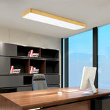 Gold LED ceiling panel lit above an office desk and shelving
