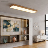 Gold LED ceiling panel lit in a room with shelving and artwork