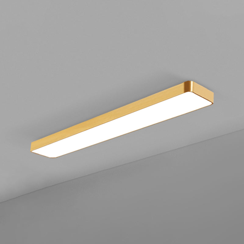 Long gold LED ceiling panel lit against a plain grey corner