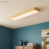 Gold LED ceiling panel fitted to a ceiling in a teal study