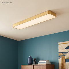 Gold LED ceiling panel fitted to a ceiling in a teal study
