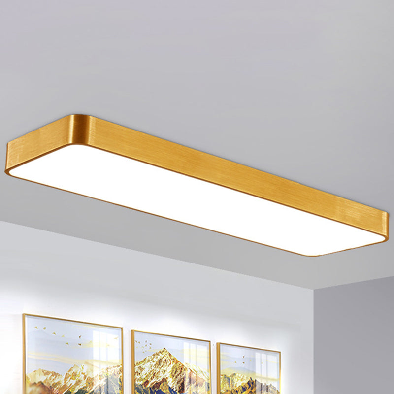Gold LED ceiling panel on a white ceiling above framed prints
