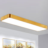 Gold LED ceiling panel on a white ceiling above framed prints
