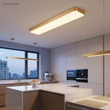 Gold LED ceiling panel lit in a white kitchen with an island