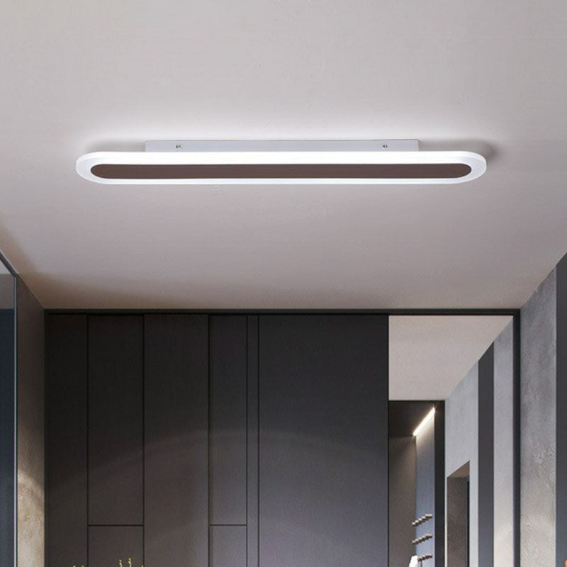 Coffee ceiling light above dark wardrobes in a bedroom