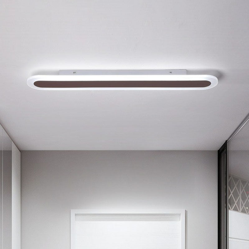 Coffee linear ceiling light mounted flush near a white doorway