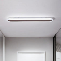 Coffee linear ceiling light mounted flush near a white doorway
